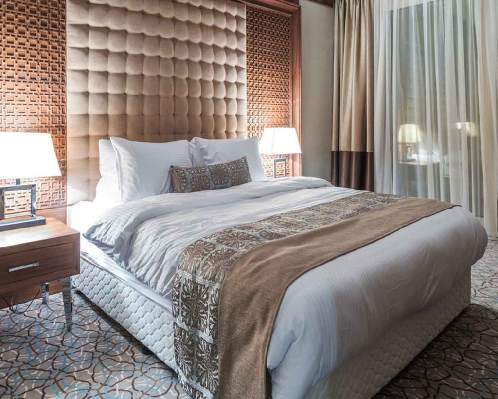 Create a Luxurious Hotel-like Bedroom - Layer your bedding 